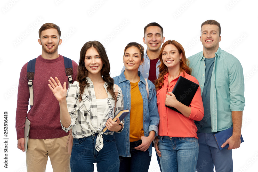 education, high school and people concept - group of smiling students with books waving hands over white background education, high school and people concept - group of smiling students with books waving hands over white background