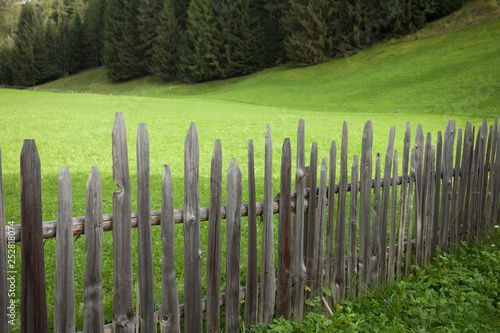 Wooden fence from a pasture in Val di Funes in Italy photo