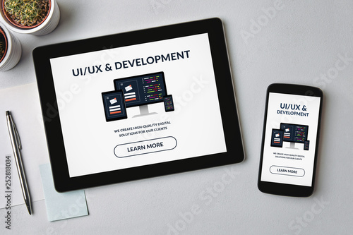 UI/UX design and development concept on tablet and smartphone screen