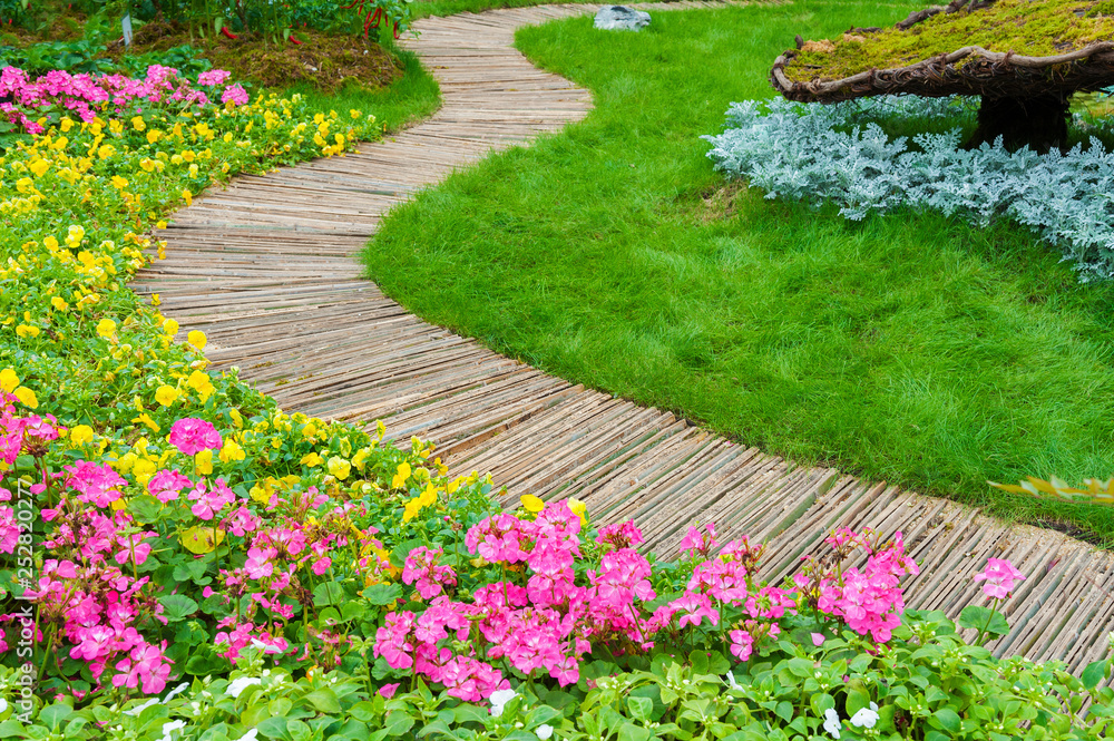 Green Path in ornate backyard flower Garden