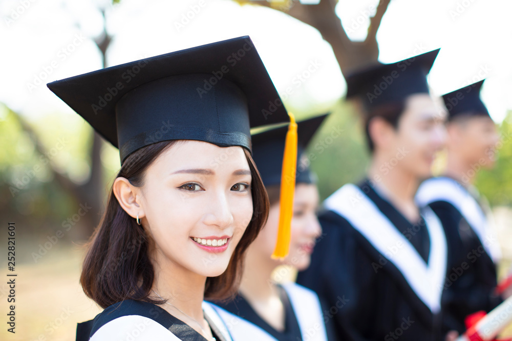 closeup smiling young woman at graduation closeup smiling young woman at graduation