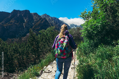 Healthy lifestyle Woman tourist backpacks mountain hiking trail