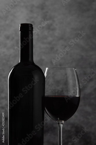 Red wine bottle and glass close-up