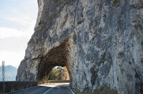 Dolomites nature. An arch made of the stone on a road
