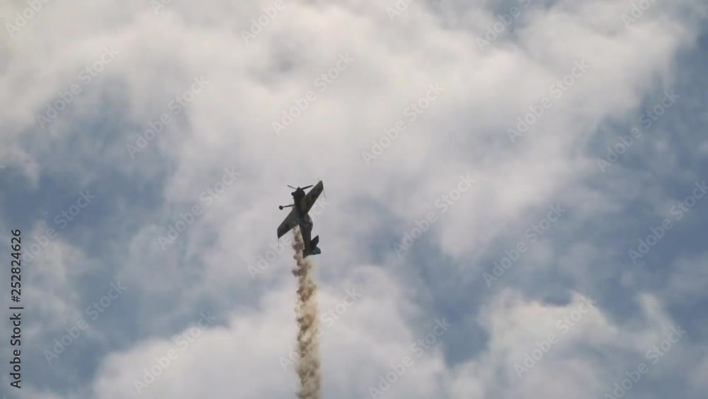 Airshow - sports airplane performs aerobatics with smoke Airshow - sports airplane performs aerobatics with smoke