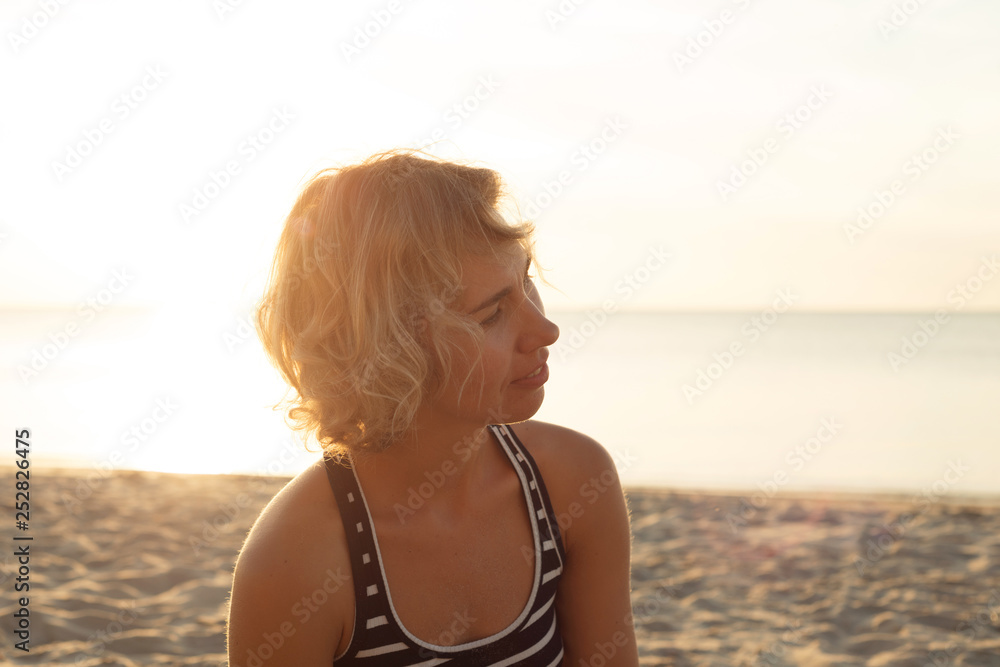 Natural portrait of a blonde woman near the sea in profile Natural portrait of a blonde woman near the sea in profile