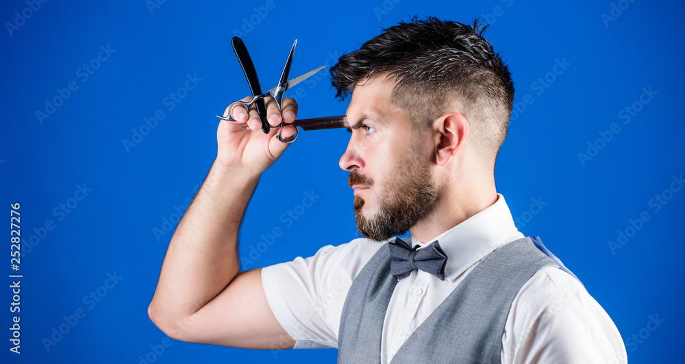 Having the right tools. Hipster with beard in razor barber shop. Bearded man with razor and scissors in retro barbershop. Man with beard and mustache in shaving salon. Barber hold vintage tools Having the right tools. Hipster with beard in razor barber shop. Bearded man with razor and scissors in retro barbershop. Man with beard and mustache in shaving salon. Barber hold vintage tools