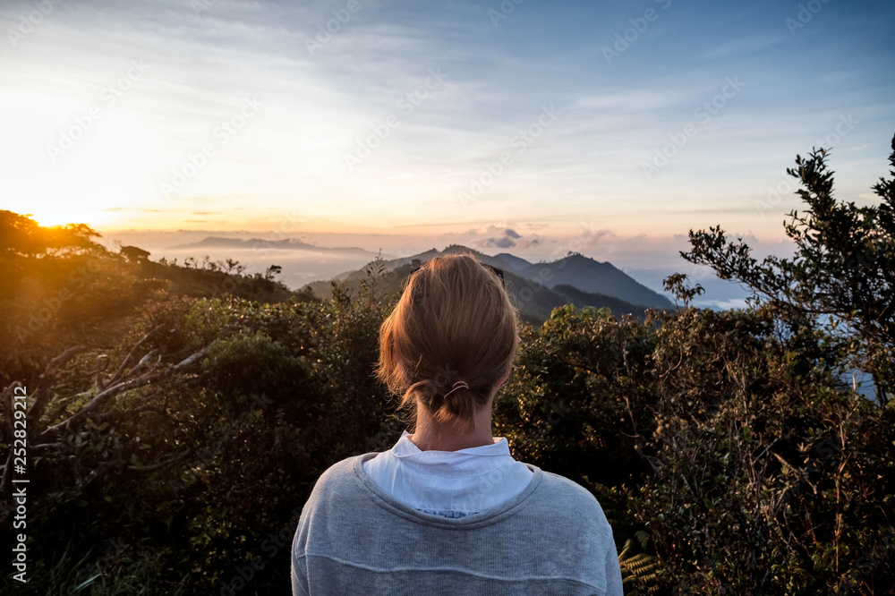 Woman standing n the viewpoint with breathtaking view over fields Woman standing n the viewpoint with breathtaking view over fields