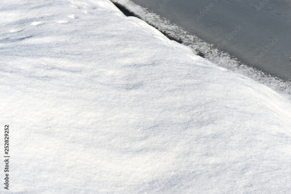 Snow and ice on a winter river. Winter texture and background