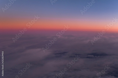 Flight scene plane window view clouds sunset