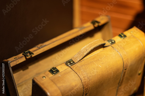 Yellow wooden suitcase for travel closeup, nostalgic luggage, vintage background