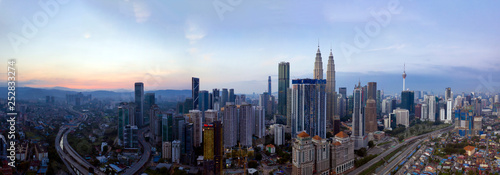 KUALA LUMPUR, MALAYSIA - FEBRUARY 3, 2019: Panoramic aerial view of Kuala Lumpur city skyline during hazy sunrise.