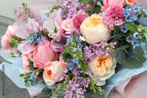 Beautiful rich elegant wedding pink bouquet, flowers arrangement by florist with roses, lilac and blue flowers. Floral background photo