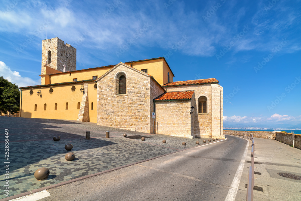 Antibes Cathedral and road along the sea in France.