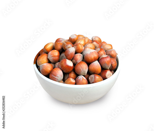 Hazelnuts in a bowl isolated on white background