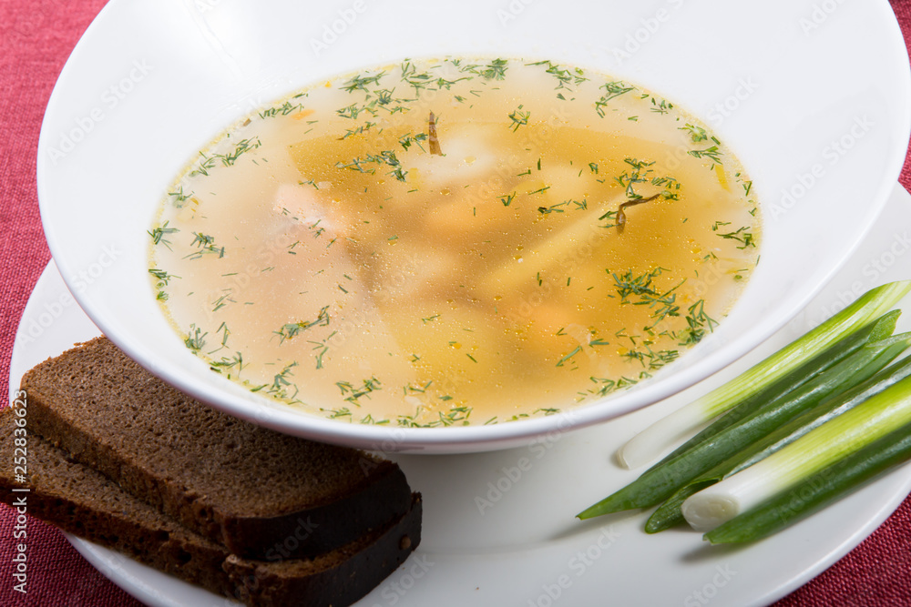 Yellow chicken soup served with leek Yellow chicken soup served with leek