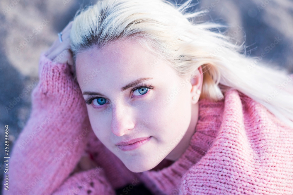 defocused portrait with focus on clear eye of a beautiful caucasian russian girl model young sit down and looking to you on camera. little smile relaxed for lifestyle and beauty concept defocused portrait with focus on clear eye of a beautiful caucasian russian girl model young sit down and looking to you on camera. little smile relaxed for lifestyle and beauty concept