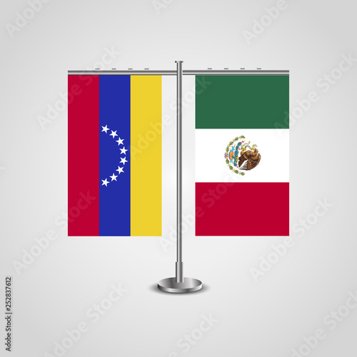 Table stand with flags of Venezuela and Mexico. Two flag. Flag pole. Symbolizing the cooperation between the two countries. Table flags