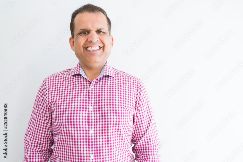 Fototapeta premium Middle age man wearing business shirt over white wall with a happy and cool smile on face. Lucky person.