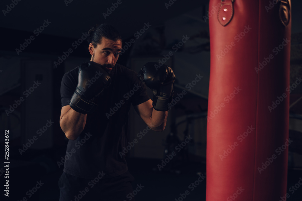 Boxer in guard in front of the heavy bag