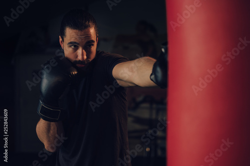 Boxer hitting the heavy bag with front jab © sasamihajlovic