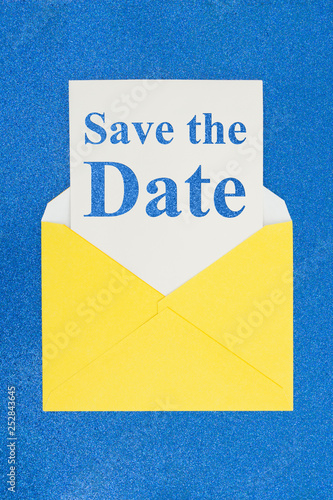 Save the Date message on white card with a yellow envelope