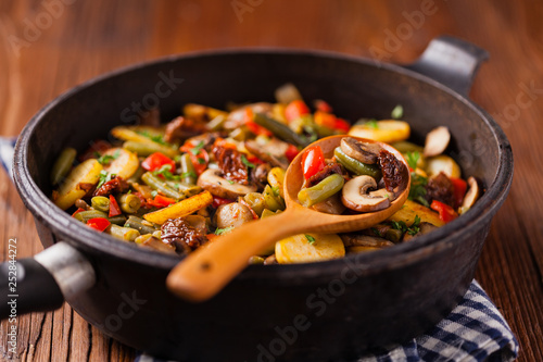 Fried pan vegetables, with mushrooms and dried tomatoes. Seasoned with a mix of herbs.