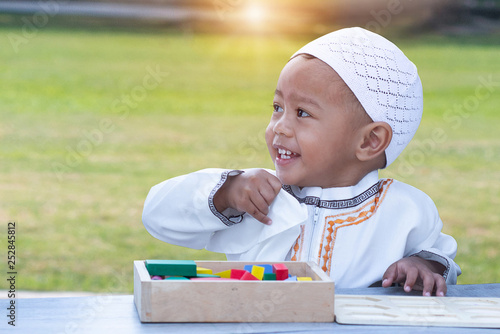 Photography Small Asian muslim child playing with wooden blocks and smiling
