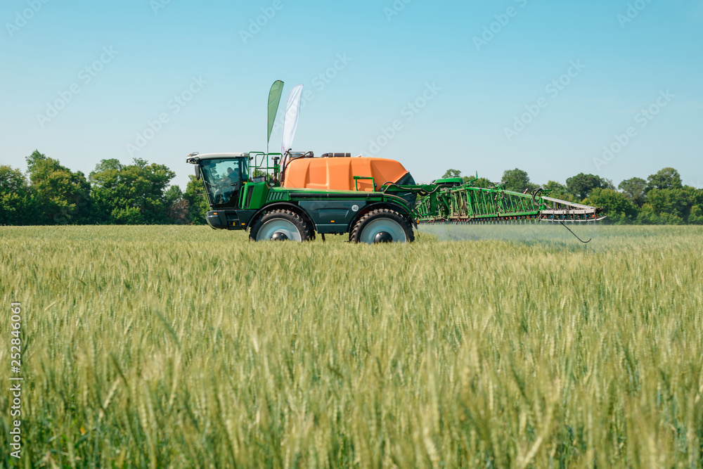 Self propelled sprayer applying pesticide Self propelled sprayer applying pesticide