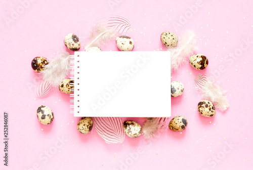 Blank greeting card. Easter composition with easter eggs and feathering on pink background. Image