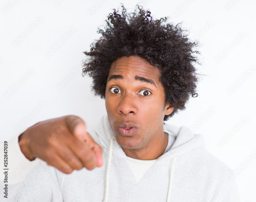 African American man over white isolated background pointing with finger to the camera and to you, hand sign, positive and confident gesture from the front African American man over white isolated background pointing with finger to the camera and to you, hand sign, positive and confident gesture from the front