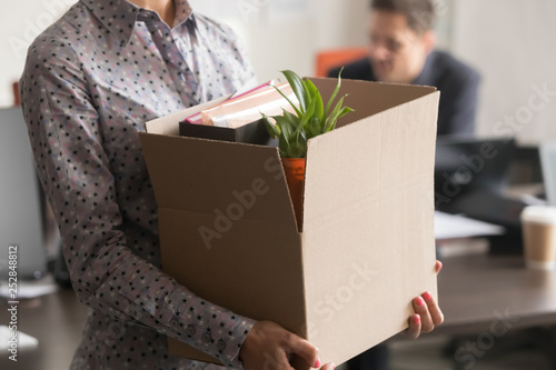 Close up view of new female employee intern holding box