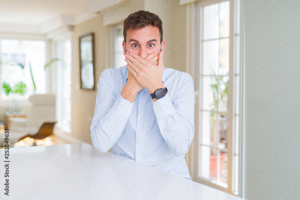 Fototapeta premium Handsome business man shocked covering mouth with hands for mistake. Secret concept.