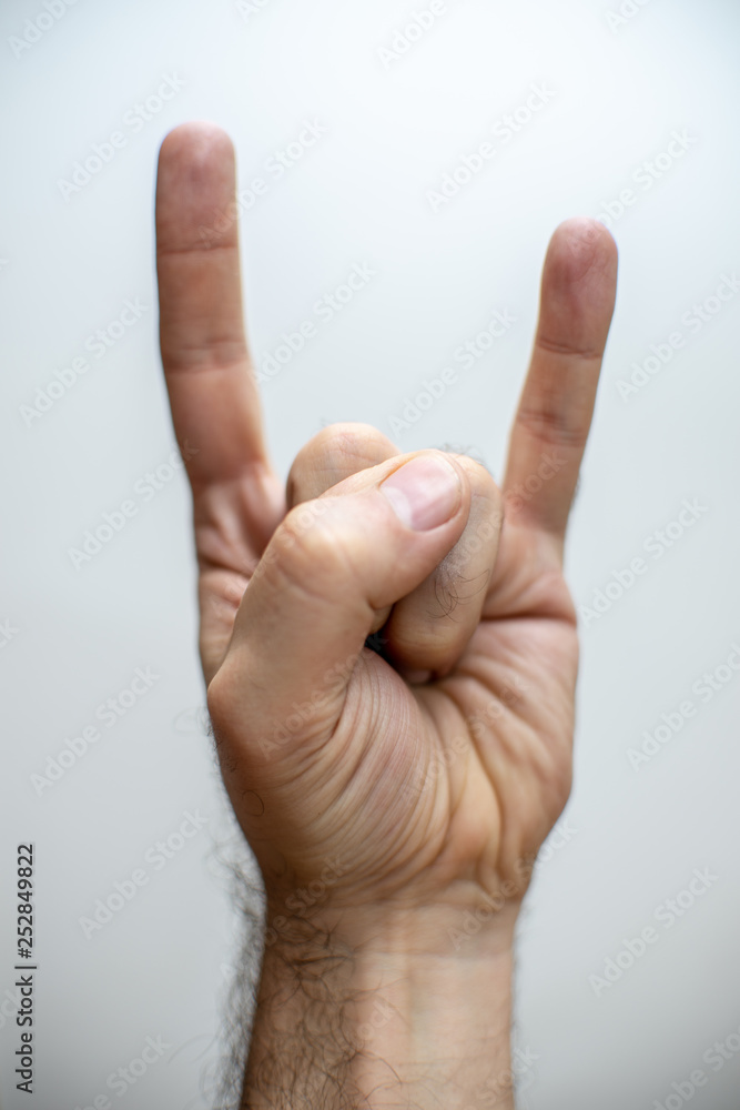 Hand doing a metal sign over white background Hand doing a metal sign over white background