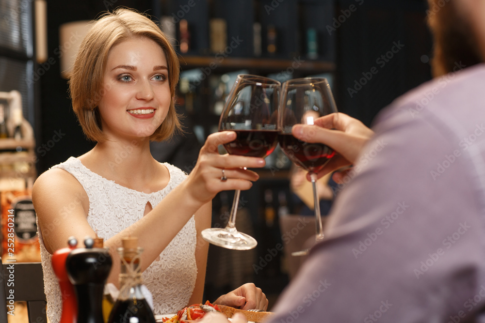 Thank you for this evening. Horizontal shot of a gorgeous woman smiling to her boyfriend having a glass of wine together at the restaurant