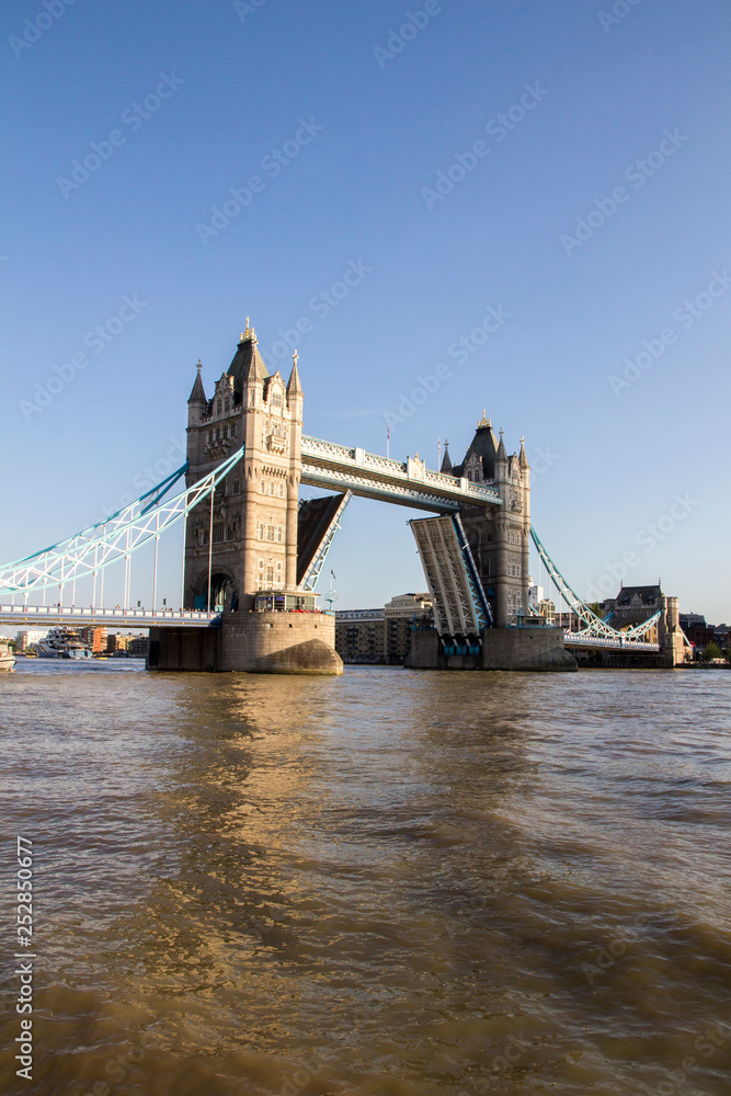 Obraz premium Tower Bridge on the River Thames opening for passing boats late afternoon. London, England, UK