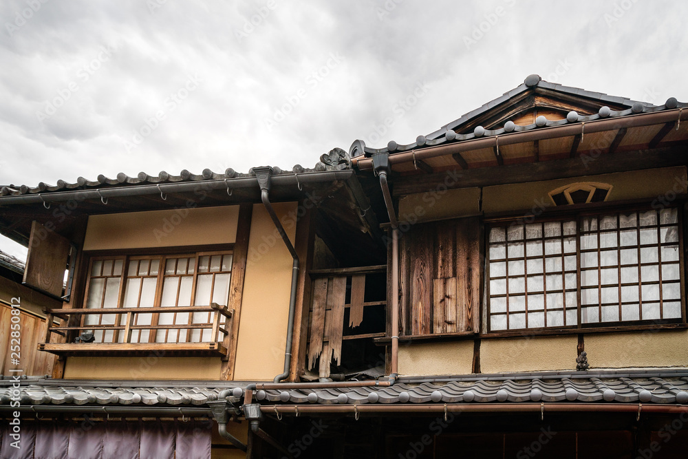 Old traditional Japanese house detail with the specific roof tiles on a street in Gion District, Kyoto, Japan.