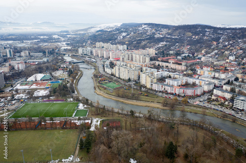 Aerial above view of river crossing the city