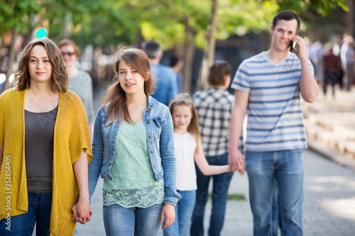 People of different ages walk in park