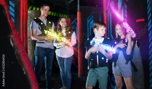 Boy and girl in beams on lasertag arena