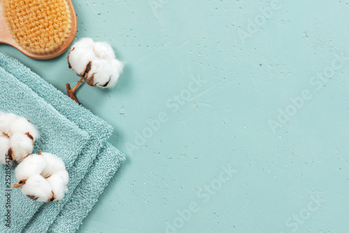 Stack of blue bath towels on the blue textured background
