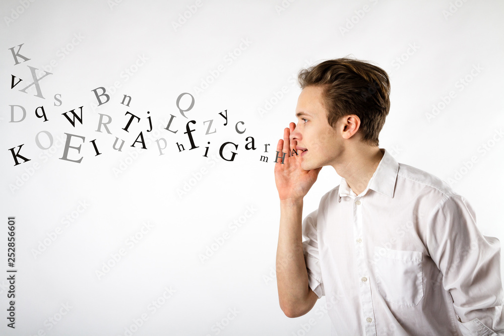 Young man is whispering. Whispering and letters concept. Young man is whispering. Whispering and letters concept.