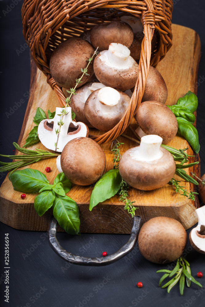Fresh champignon mushrooms on dark wooden table Fresh champignon mushrooms on dark wooden table