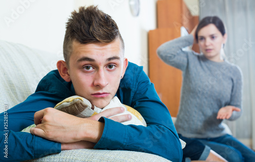 Mother and teenager son having fight at home photo