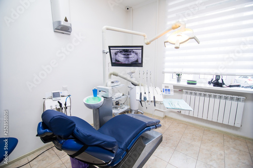 dentistry, medicine and stomatology concept - modern dental clinic office interior bokeh