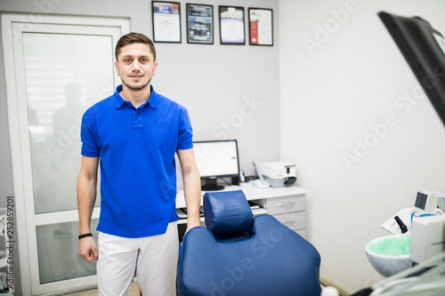 Portrait of a dentist  young man at his workplace in the dental clinic.