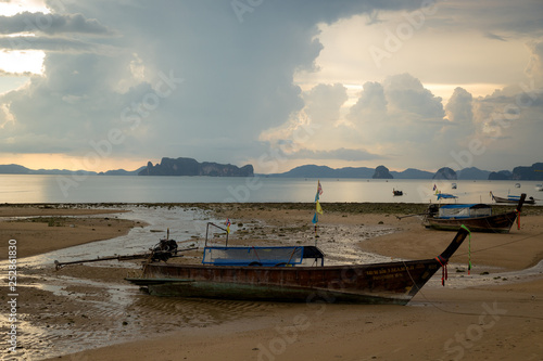 Tropical beach  long tail boats golden sunset  gulf of Thailand Krabi 