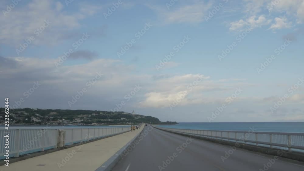 Landscape view of the bridge while crossing the okinawa sea on okinawa island from inside the car while moving on the bridge Landscape view of the bridge while crossing the okinawa sea on okinawa island from inside the car while moving on the bridge