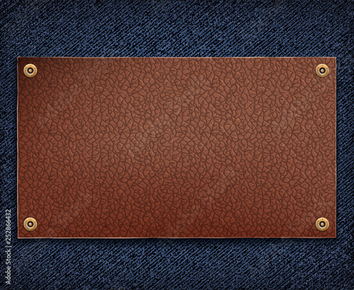 Background of blue denim fabric with leather tag.