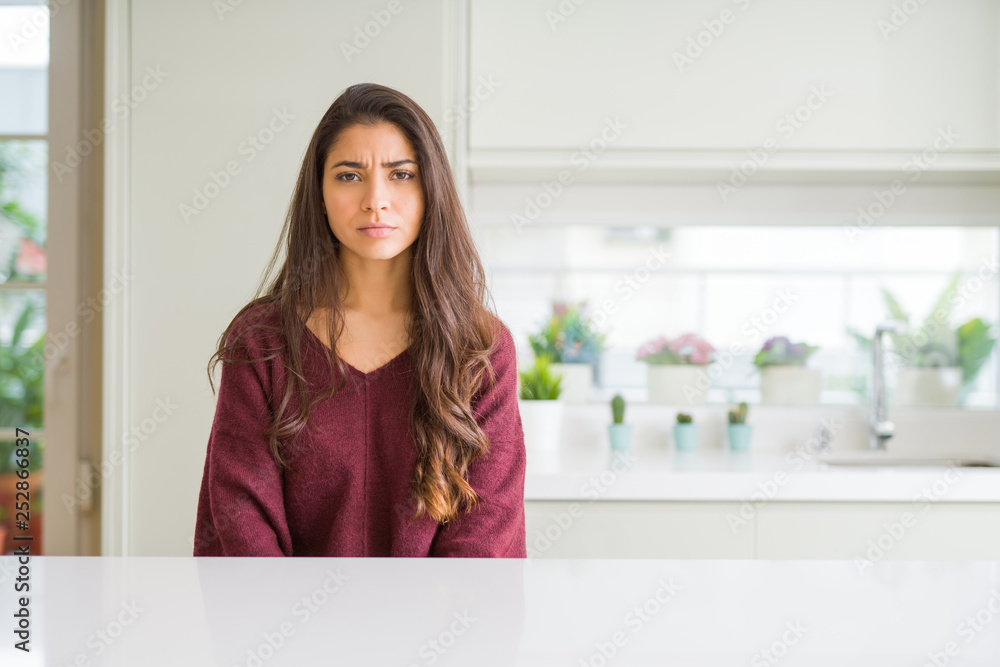Young beautiful woman at home skeptic and nervous, frowning upset because of problem. Negative person. Young beautiful woman at home skeptic and nervous, frowning upset because of problem. Negative person.